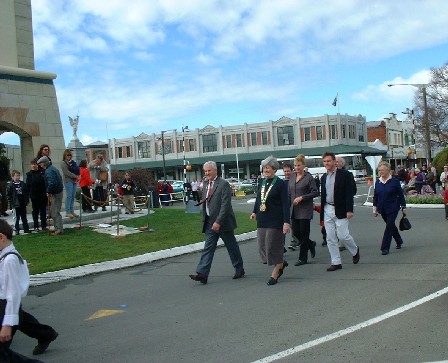 Committee walking in to hand-over ceremony lead by Feilding Pipe Band