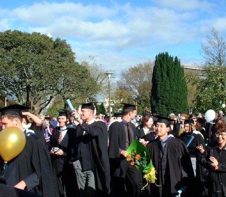 Massey University Graduates proceed out of the Regent on Broadway to celebrate in The Square, Palmerston North, Manawatu, New Zealand - 13 May 2002