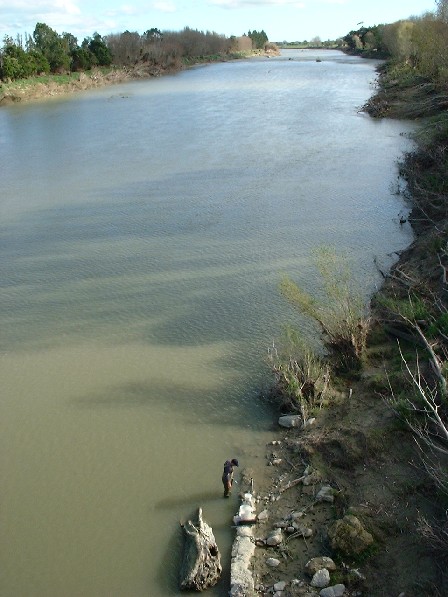 Not its typical colour. Jamie (bottom centre) from NIWA does a monthly water quality test - something that's been done for the past 18 years - just below Fitzherbert Bridge, Manawatu River, Manawatu, New Zealand - 19 May 2004